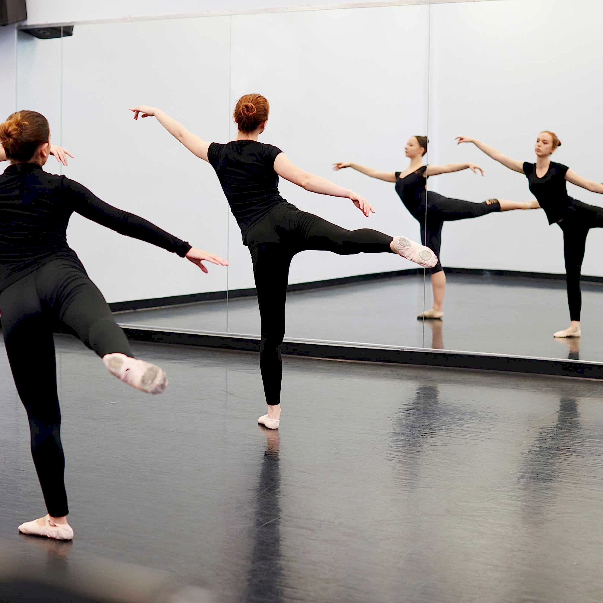 AdobeStock_254376580-square women dancing in front of a mirror in a dance studio